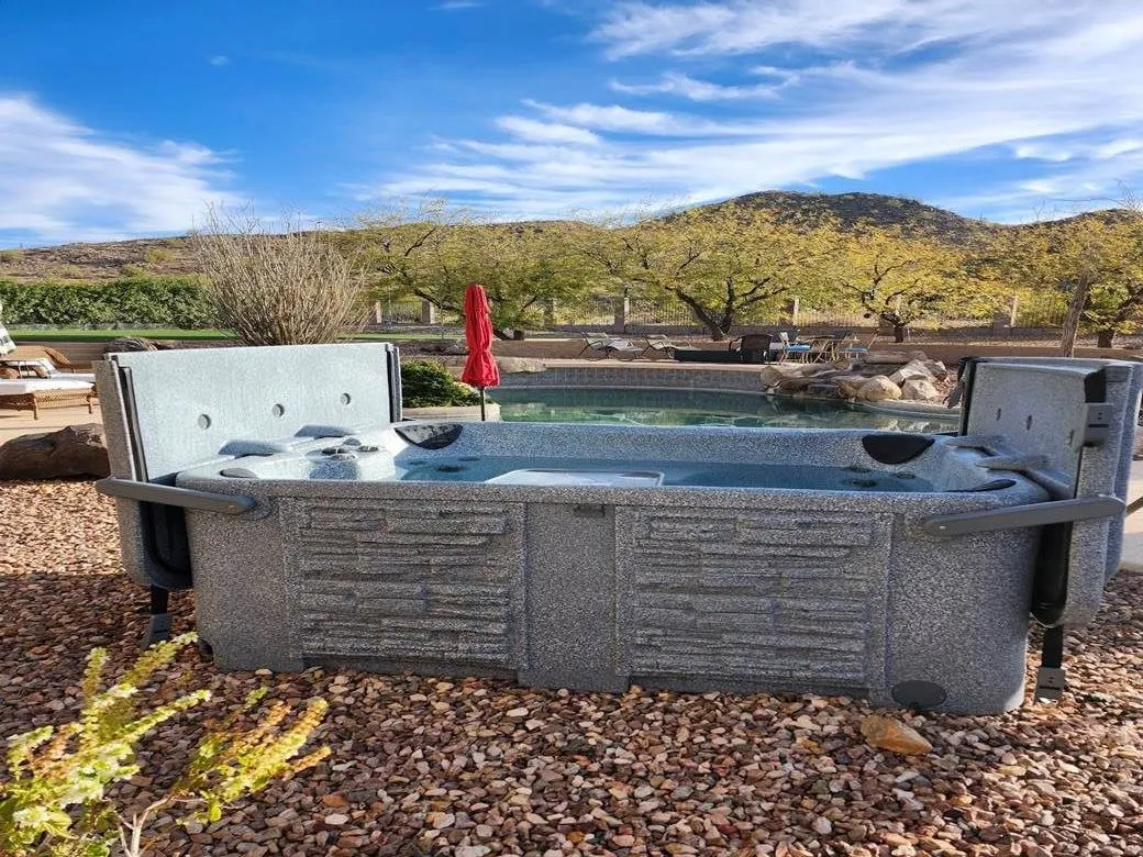 The outdoor hot tub, looking out over the pool to the hills