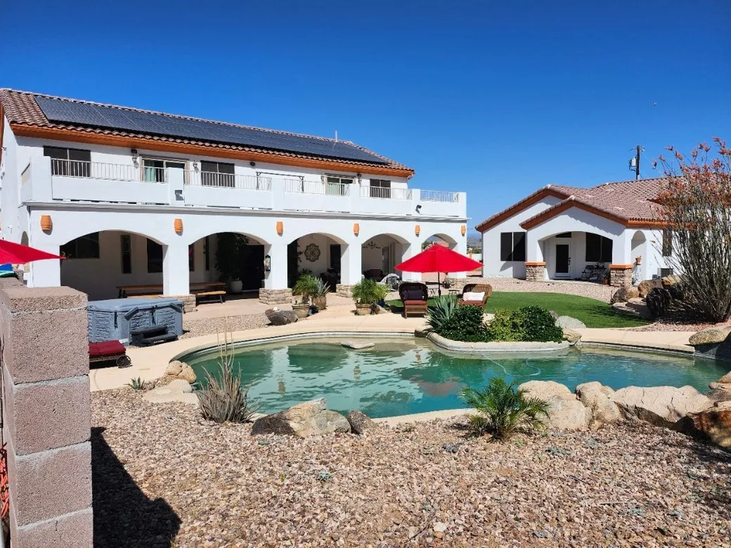 The courtyard pool below the arched patio of the two-story retreat house
