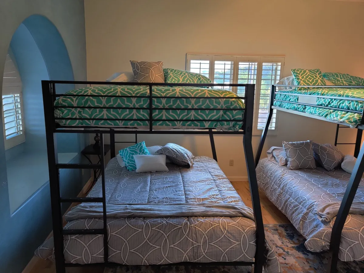 The Peace Room: two bunk beds with patterned bedding and blue walls