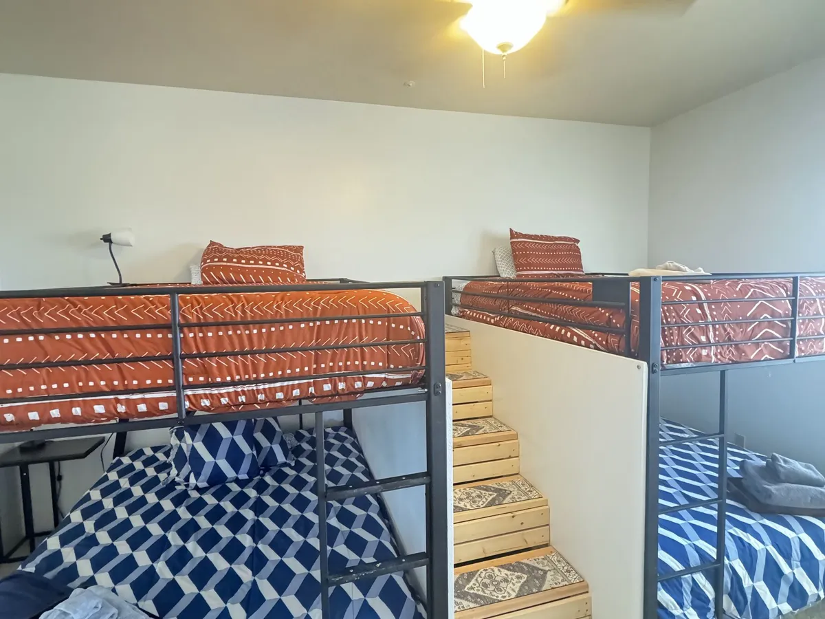 The Tranquility Room: bunk beds with blue plaid bedding and orange quilts