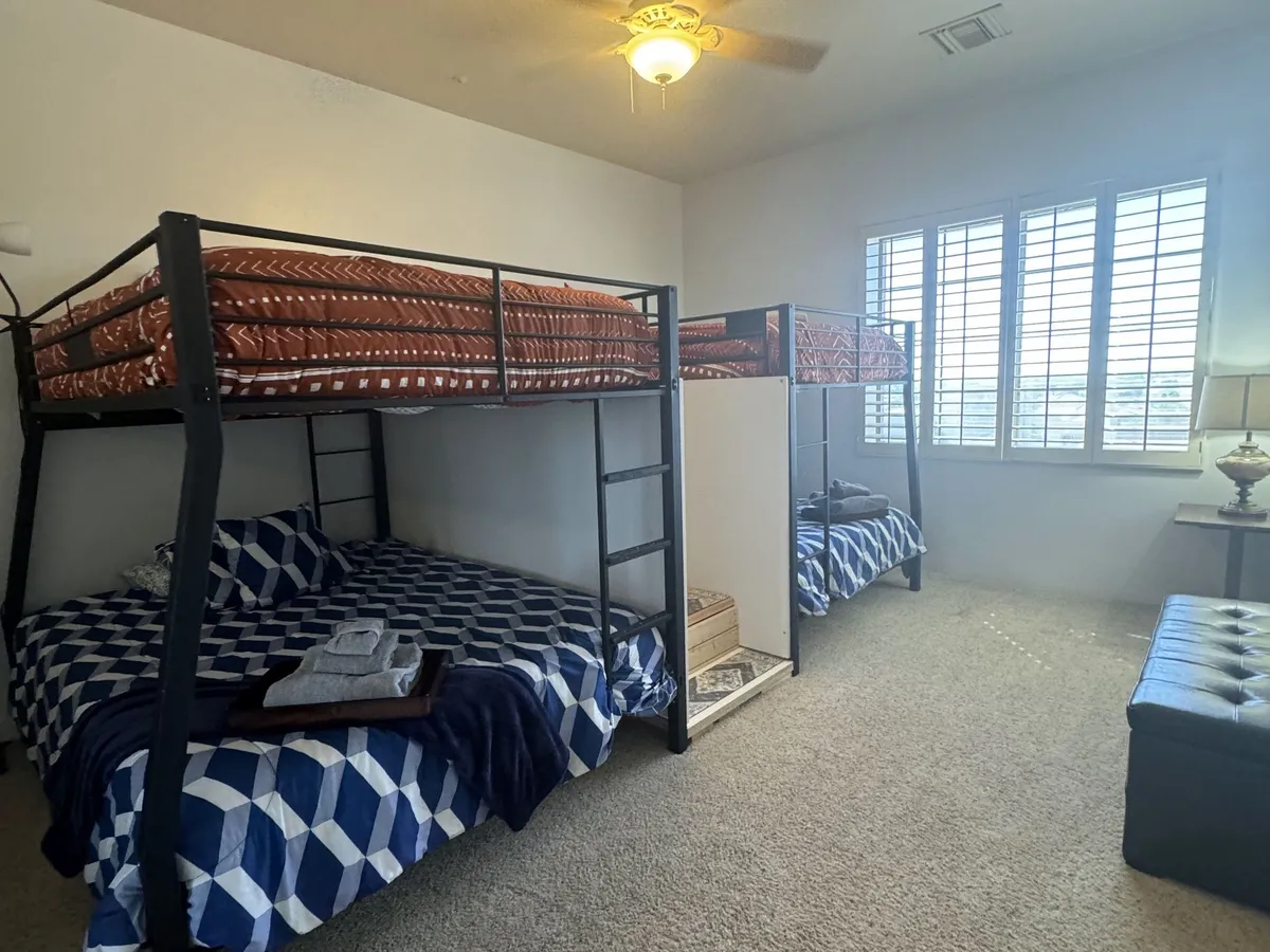 The Tranquility Room: bunk beds with blue bedding beside shuttered windows